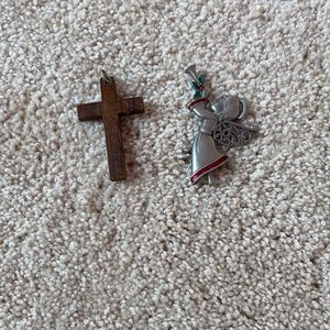 I’m selling a cross that can go on a necklace and an angel blowing a horn pin